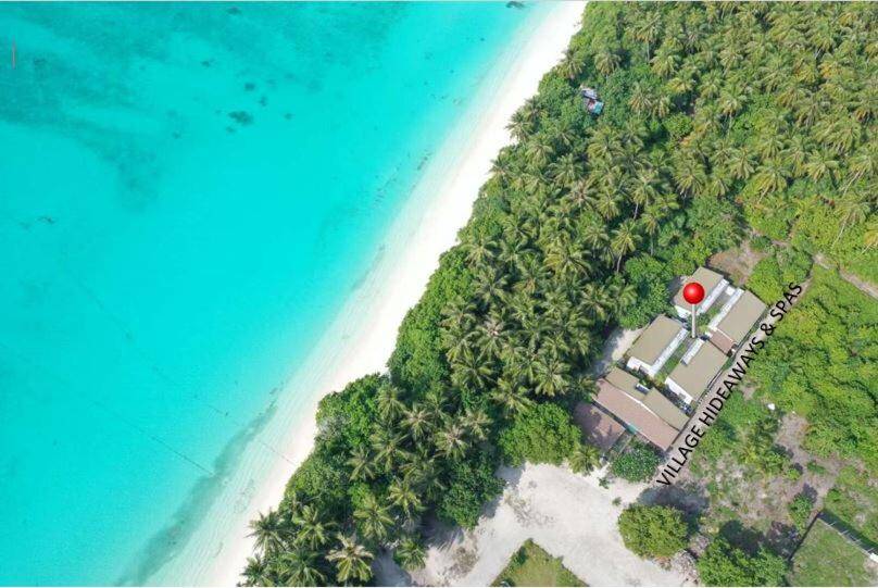 Aerial view of the beach and palms at Village Hideaways & Spas, Fulhadhoo, Maldives